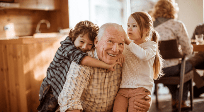 Grandfather hugging grandkids