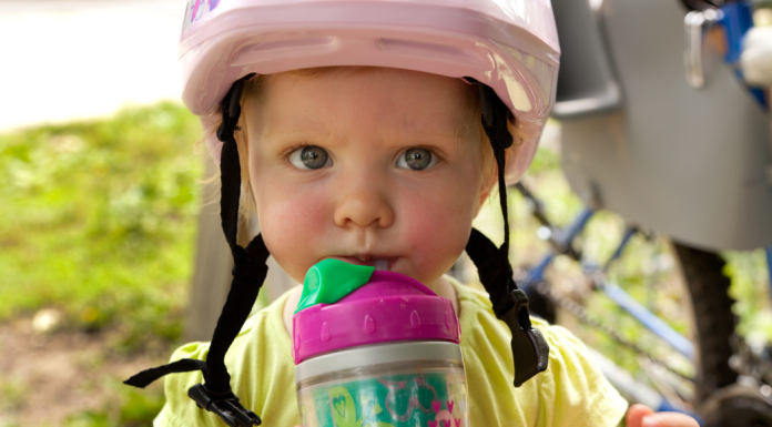 toddler girl wearing a pink bike helmet