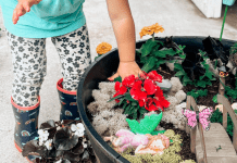 a young toddler making a fairy garden