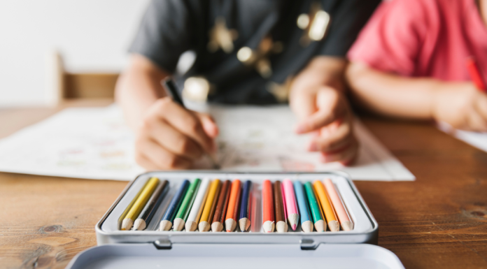 Kids using colored pencils in their homeschool program