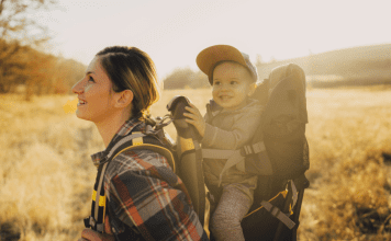 women hiking with a baby in a hiking carrier