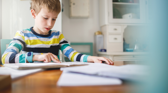 boy at kitchen table doing school work