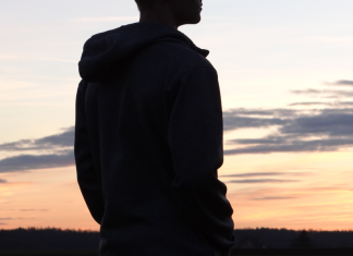 silhouette of teenage boy at sunset