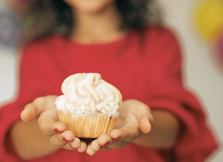 woman holding a cupcake