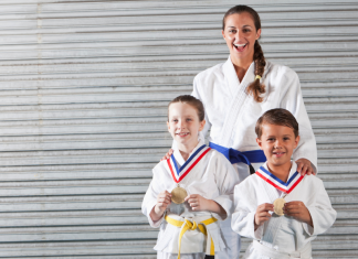 jiu jitsu instructor with two young students