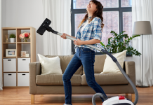 Woman using a vacuum as an air guitar