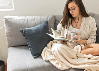 woman on couch reading a book
